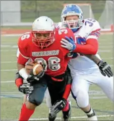  ?? Photos by John Gleeson ?? Bristol senior fullback Willie Sutton gains positive yardage for the Warriors, who saw their state playoff run come to an end last Friday.