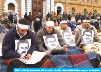  ??  ?? ROME: In this file photo, Kurds with portraits of Kurdish rebel Abdullah Ocalan, leader of the Kurdistan Workers Party (PKK) read the Italian press as they sit in front of Celio military hospital in Rome. — AFP