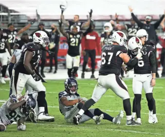  ?? ROB SCHUMACHER/THE REPUBLIC ?? Cardinals kicker Zane Gonzalez (5) and teammates react after his game-winning field goal in overtime against the Seahawks on Sunday night in Glendale.