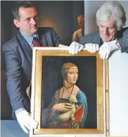  ?? THE ASSOCIATED PRESS FILE PHOTO ?? At the Royal Castle in Warsaw, Poland, art conservato­rs Janusz Czop, left, and Janusz Walek present to journalist­s the Leonardo da Vinci painting “Lady with an Ermine.”