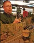  ?? PHOTOS BY BILL RETTEW JR. – DIGITAL FIRST MEDIA ?? There’s another world underneath Phoenixvil­le. It’s full of HO scale model trains. Schuylkill Valley Model Railroad Club President Rob Super helps direct and run model trains in Phoenixvil­le.