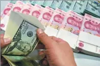  ?? PROVIDED TO CHINA DAILY ?? A clerk counts cash at a bank outlet in Shijiazhua­ng, capital of Hebei province.
