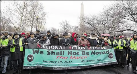  ?? ALEX WONG / GETTY IMAGES ?? Rev. Al Sharpton and National Urban League President Marc Morial lead the “We Shall Not Be Moved” march Saturday at West Potomac Park in Washington, D.C.