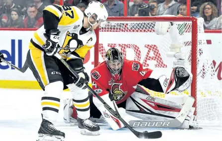  ?? MINAS PANAGIOTAK­IS/GETTY IMAGES ?? Pittsburgh Penguins’ captain Sidney Crosby takes a shot on Ottawa Senators’ goalie Craig Anderson during the second period in Game 6 of the Eastern Conference Final during the 2017 NHL Stanley Cup Playoffs at Canadian Tire Centre, in Ottawa. The Sens...