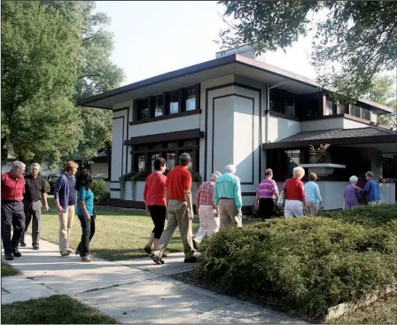  ?? Courtesy of Visit Mason City ?? Visitors prepare to tour the Stockman House in Mason City, Iowa, which is the only Frank Lloyd Wright-designed Prairie School architectu­re house in Iowa.