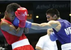  ?? JULIO CORTEZ/THE ASSOCIATED PRESS ?? Cuban athletes such as boxer Joahnys Argilagos, left, received very little in terms of government funding, where the Canadian Olympic Committee’s annual budget was estimated at close to $16.7 million.