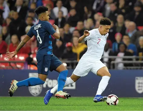  ?? GETTY IMAGES ?? Jadon Sancho of England is challenged by Weston McKennie of the United States in Thursday night’s friendly at Wembley