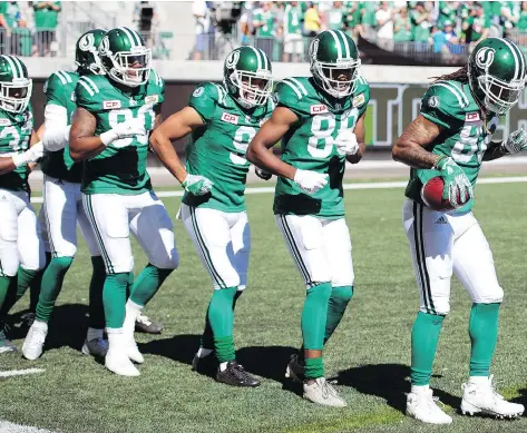  ?? TROY FLEECE ?? Saskatchew­an Roughrider­s receiver Naaman Roosevelt, far right, leads his teammates in a conga line after scoring a touchdown Sunday against the Winnipeg Blue Bombers. The Riders have had a good reason to celebrate lately as the team is on a three-game...