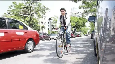  ??  ?? Swifter option: Wong says getting around Kuala lumpur by bicycle is just as quick as driving.