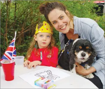  ?? BARB AGUIAR/Special to The Daily Courier ?? Fern Calder, 2, sips lemonade while sitting with her mom, Claire, and Murphy the King Charles Spaniel.