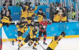  ?? STEVE RUSSELL TORONTO STAR ?? Canada’s Mat Robinson is surrounded by delirious German players at the end of Friday’s semifinal.