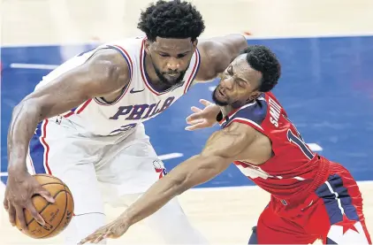  ?? AFP ?? Philadelph­ia’s Joel Embiid dribbles past Washington’s Ish Smith during the fourth quarter at Wells Fargo Center.