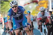  ?? CHRISTOPHE ENA THE ASSOCIATED PRESS ?? Italy’s Elia Viviani celebrates as he crosses the finish line to win the fourth stage of the Tour de France cycling race Tuesday.