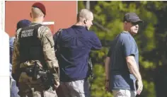  ?? THE ASSOCIATED PRESS ?? Bowe Bergdahl, center, leaves the Fort Bragg courtroom facility following his Friday sentencing. The former sergeant was spared prison time and received a dishonorab­le discharge.