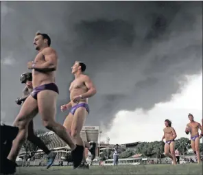  ?? PICTURE: MOTSHWARI MOFOKENG ?? ON THE RUN: Athletes take part in the Hollard Daredevil Run to raise awareness for Cancer at Kings Park yesterday. The runwent ahead despite the heavy cloud of smoke.