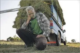  ?? Carolyn Cole Los Angeles Times ?? “TEN YEARS ago, I swear, our water was fresh and plenty,” said Karim Baluchi, who now earns his income by hauling hay. “Ten years ago I had a decent life.”