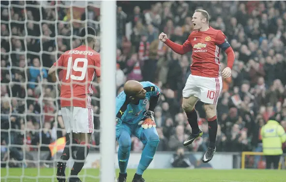  ?? — GETTY IMAGES ?? Wayne Rooney, right, celebrates scoring the opening goal and equalling Bobby Charlton’s Manchester United all-time scoring record during Saturday’s English FA Cup third round match against Reading at Old Trafford in Manchester.