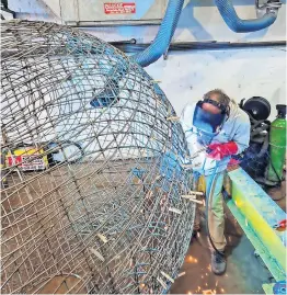  ?? ?? On the ball Arnd welding his cage in the factory at James Cowie, Blantyre