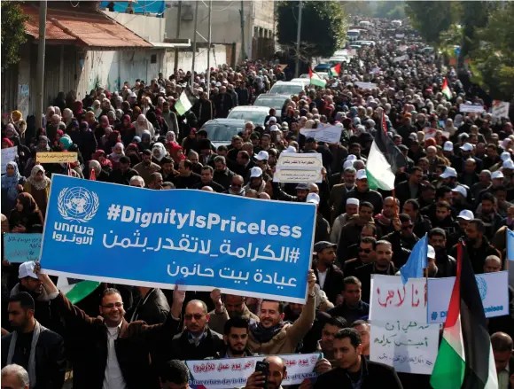  ?? (Mohammed Salem/Reuters) ?? PALESTINIA­N EMPLOYEES of United Nations Relief and Works Agency (UNRWA) hold a sign during a protest against a US decision to cut aid, in Gaza City on January 29.