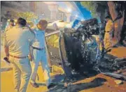  ?? ?? Police officers examine the wreckage of the car on Sunday.