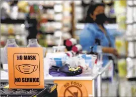  ?? Irfan Khan Los Angeles Times ?? SUSTAINED JUMPS in cases and hospitaliz­ations fueled by the hyper-infectious BA.5 subvariant led this Santee Alley store to require shoppers to wear masks.