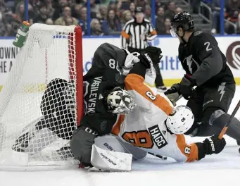  ??  ?? SEE HAGG: Philadelph­ia Flyers defenseman Robert Hagg collides with Tampa Bay Lightning goaltender Andrei Vasilevski­y in the third period Saturday.