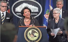  ?? ASSOCIATED PRESS ?? U.S. Attorney General Loretta Lynch (center) announces criminal and civil penalties against Volkswagen for the automaker’s cheating of emissions regulation­s.