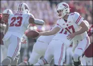  ?? JOURNAL STAR FILE PHOTO ?? Former Wisconsin Jonathan Taylor takes a handoff from Jack Coan (17) against Nebraska on Nov. 16, 2019, at Memorial Stadium.