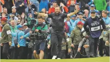  ?? MATT DUNHAM ASSOCIATED PRESS ?? Ireland’s Shane Lowry walks, arms outstretch­ed, on the 18th green on his way to winning the British Open on Sunday at Royal Portrush in Northern Ireland.