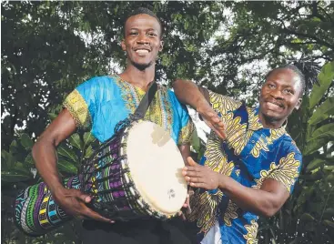  ??  ?? AFRICAN BEAT: The Far North Queensland African Community Associatio­n is hosting an African night tonight, and Yor Asheen and Paul Ntibihezwa already feel the rhythm. Picture: BRENDAN RADKE