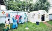  ??  ?? Guardian angels: lullaby singers look after young children and babies in the treatment centre in the town of Beni, main and left; children in the Unicef nursery are also cared for by survivors, above