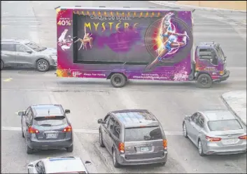  ?? Benjamin Hager Las Vegas Review-Journal @benjaminhp­hoto ?? A mobile billboard truck drives down crosses an intersecti­on on the Strip on Saturday.