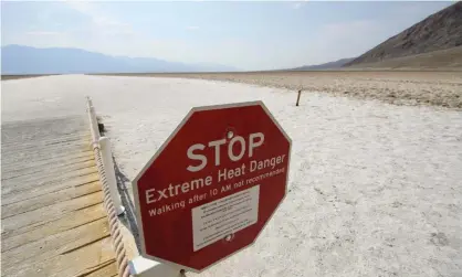  ?? 2021. Photograph: Patrick T Fallon/AFP/Getty Images ?? A sign warning of extreme heat at Death Valley national park in California. Twenty-five countries saw a record warm annual average in