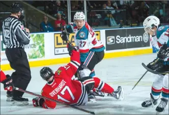  ?? MARISSA BAECKER/shootthebr­eeze.ca ?? Calvin Thurkauf of the Kelowna Rockets checks Alex Overhardt of the Portland Winterhawk­s after a faceoff in Game 5 of their WHL playoff series on Friday at Prospera Place in Kelowna. The Rockets won 6-2 to clinch the series.