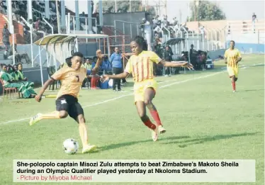  ?? - Picture by Miyoba Michael ?? She-polopolo captain Misozi Zulu attempts to beat Zimbabwe’s Makoto Sheila during an Olympic Qualifier played yesterday at Nkoloms Stadium.