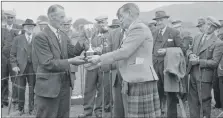  ??  ?? Donald Armour, Kilkeddan, receives the Tom Douglas Cup from the Duke of Argyll for the 1959 champion Ayrshire.