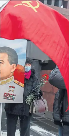  ??  ?? Russians show their support for Stalin at his grave in Red Square, above and, below, matryoshka dolls of Vladimir Putin and Joseph Stalin are proving popular