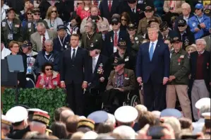  ?? SEAN GALLUP/ GETTY IMAGES ?? U.S. President Donald Trump and French President Emmanuel Macron stand as American Battle of Normandy veterans and family members look on during the main ceremony to mark the 75th anniversar­y of D-Day at Normandy American Cemetery near Colleville-SurMer, France on Thursday.