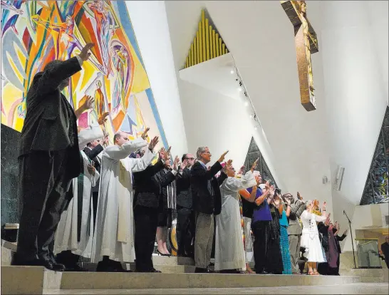  ?? Brett Le Blanc ?? Las Vegas Review-journal Religious leaders sing Sunday during an interfaith service held in remembranc­e of Oct. 1 victims and heroes at Guardian Angel Cathedral in Las Vegas.