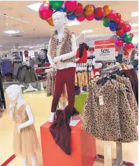  ?? ASSOCIATED PRESS ?? A children’s clothing display at a Macy’s in New Jersey. The retailer says store traffic has been high this holiday season.