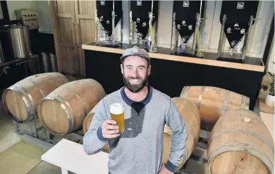  ?? PHOTO: GREGOR RICHARDSON ?? Cheers . . . After years of honing his brewing skills at home, Dunedin builder Jono Walker is finally realising his dream of running a brewery in the city.