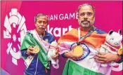  ??  ?? Gold medallist India's Pranab Bardhan and Shibhnath Sarkar with the Indian tricolour after winning in bridge competitio­n on Saturday.