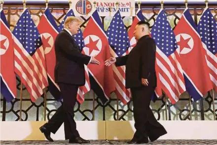  ?? REUTERS PIC ?? United States President Donald Trump (left) and North Korean leader Kim Jong-un shake hands before their one-on-one chat at the Metropole Hotel in Hanoi yesterday.
