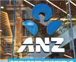  ??  ?? A file photo shows an ANZ sign adorning a branch of the bank in Sydney. —AFP