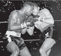  ??  ?? Sugar Ramos, right, trades punches with Davey Moore in 1963 during a fight in which Ramos won the featherwei­ght title. Moore died two days after the match, sparking an outcry about boxing safety. | AP