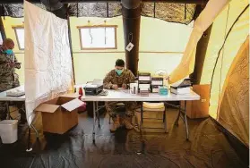  ?? Ricardo B. Brazziell / Austin American-Statesman ?? Army Spc. Jonathan Pena prepares a coronaviru­s test for people who enter the Capitol on Tuesday, the first day of the 87th Legislatur­e, in Austin.