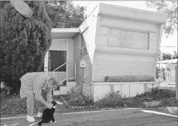  ?? Gary Friedman Los Angeles Times ?? SUPERVISOR­S have given L.A. County department­s six months to amend the county code and cap annual rent increases. Above, David Latham with his cat at a mobile home park in Santa Monica in 2012.