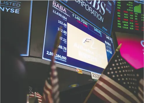  ?? Michael Nagle / Bloombe rg files ?? A monitor displays Alibaba Group Holding Ltd. signage on the floor of the New York Stock Exchange. Investors are worried how the blacklist will apply hit shares in U. S.-listed Chinese tech stalwarts Alibaba and Tencent Holdings.