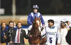  ?? Virendra Saklani/Gulf News ?? Barnamaj, ridden by Jim Crowley and trained by Ali Rashid Al Rayhi, after winning the Al Maktoum Challenge Round 2 at Meydan yesterday.