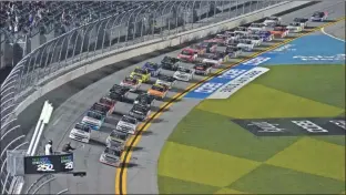  ?? AP - Chris O’meara ?? Johnny Sauter leads the field to start the season-opening Camping World Truck Series race Feb. 12 at Daytona Internatio­nal Speedway.